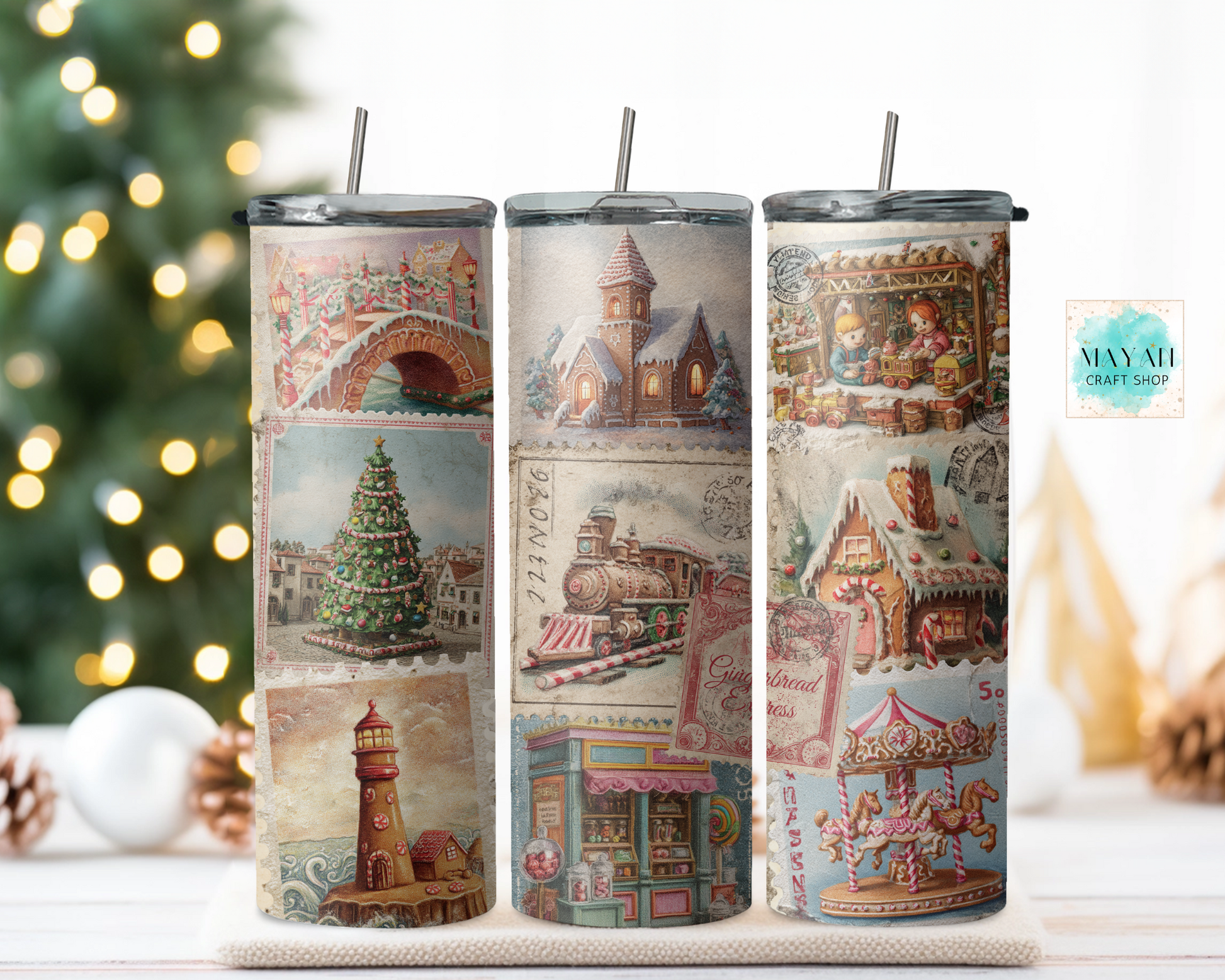 Three tumblers with vintage-themed designs on a table with a Christmas tree in the background.