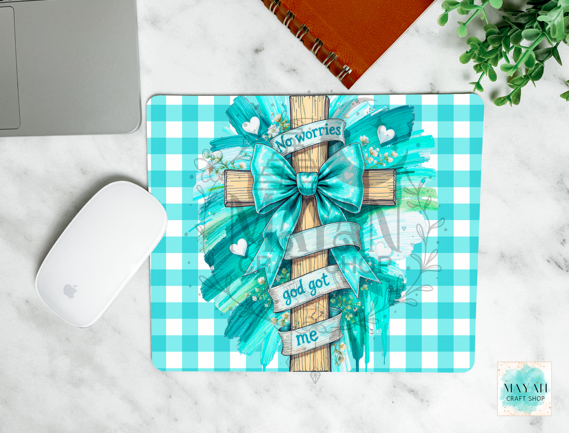 Decorative mouse pad with a checkered pattern, bow, and motivational text on a marble surface.