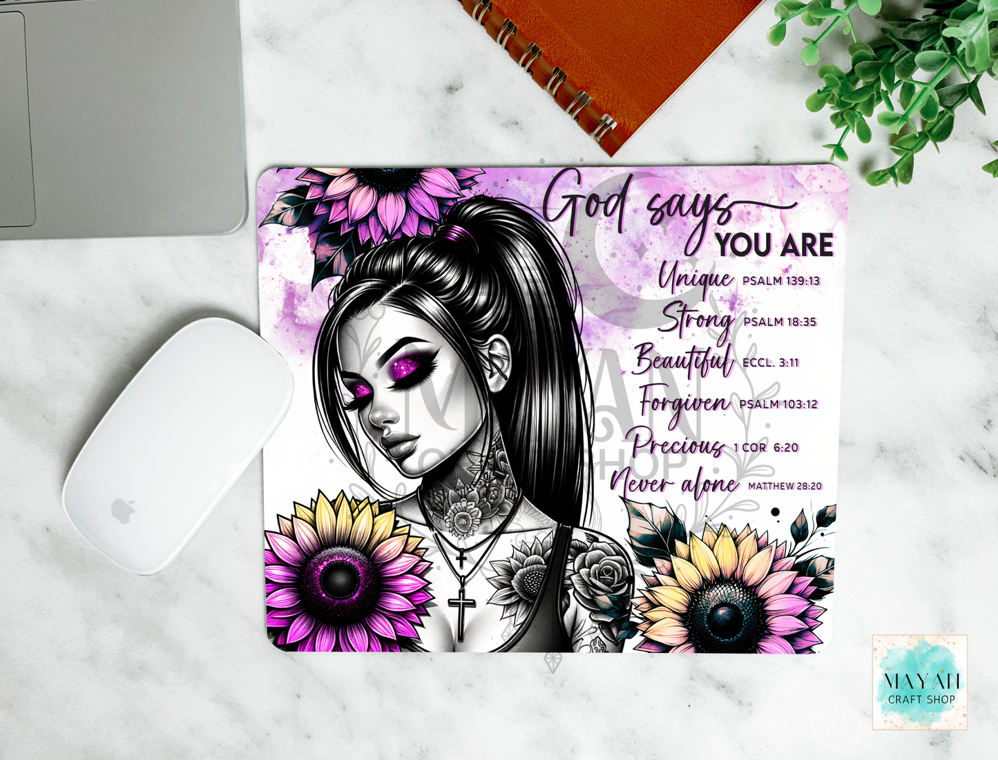 Mouse pad with a design of a woman with tattoos and flowers on a marble surface.