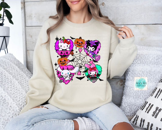 Person wearing a cream sweatshirt with colorful skeleton-themed designs sitting on a couch.