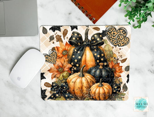 Decorative mouse pad with pumpkins and bows on a marble surface