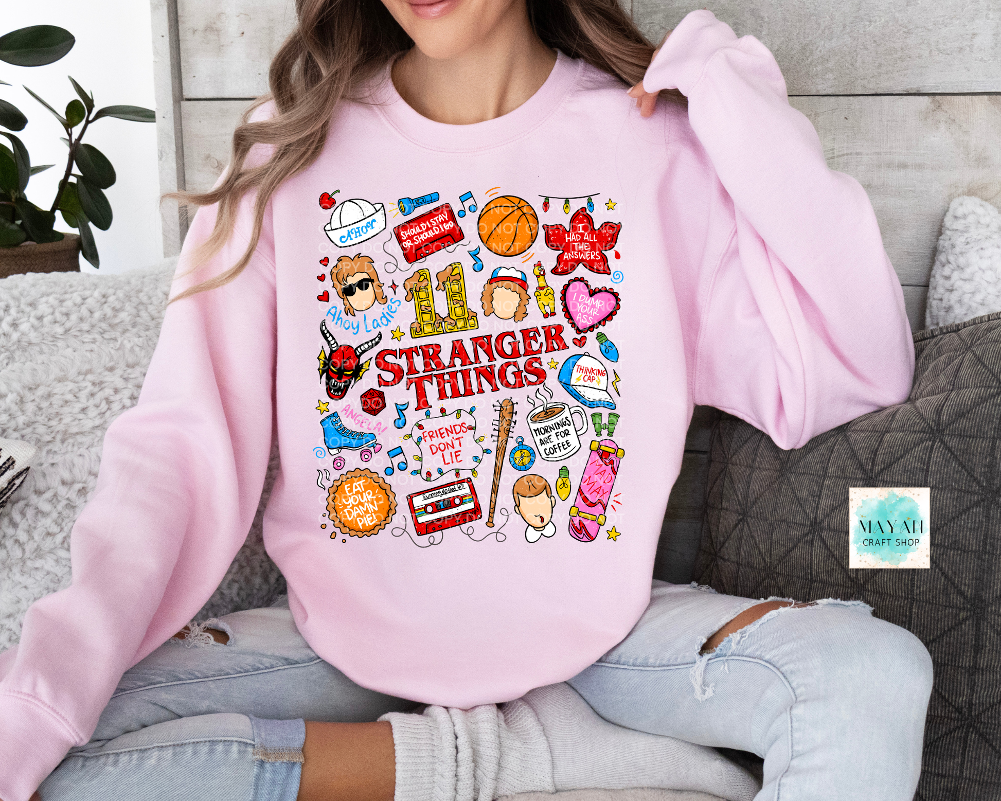 Person wearing a pink 'ST doodles' themed sweatshirt with colorful graphics.