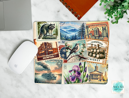 Decorative mouse pad with scenic and themed designs on a marble surface.