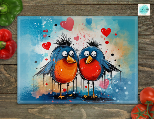 Colorful cutting board of two birds with hearts on a wooden surface
