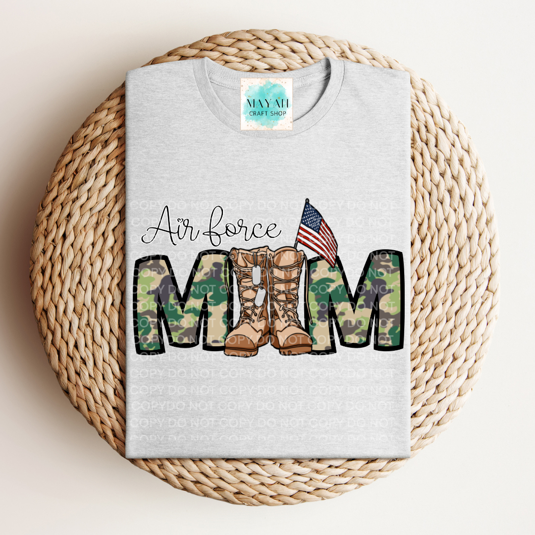 Gray sweatshirt with military mom text and camouflage boots design on a woven mat.