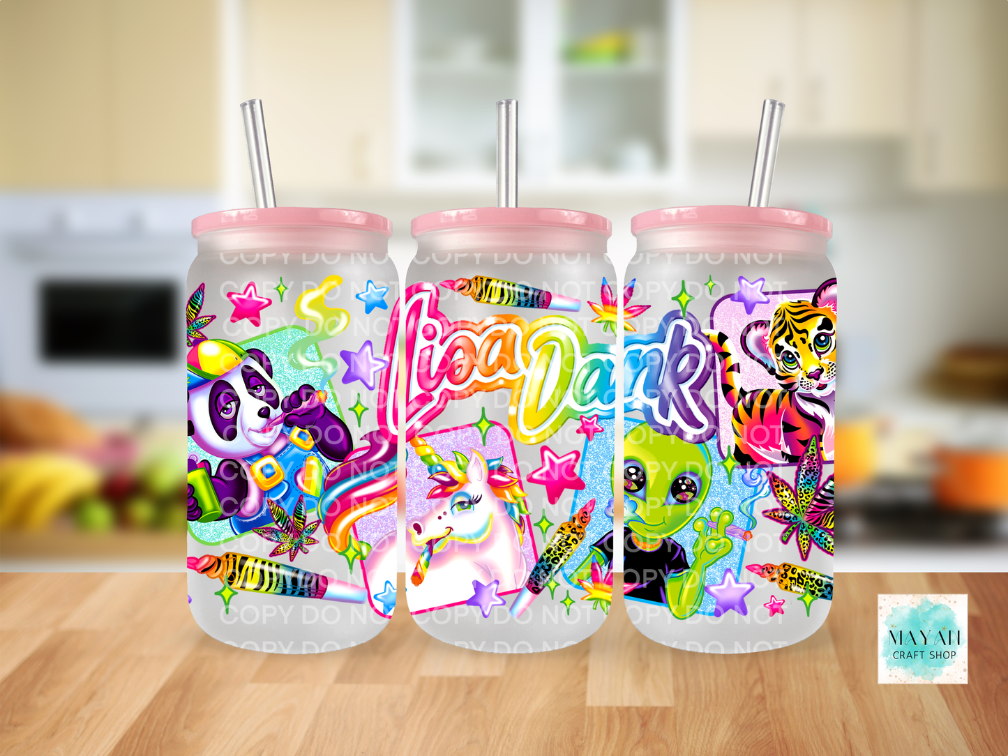 Three colorful tumbler cups with animal designs on a wooden surface.