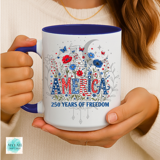 Person holding a mug with 'America 250 Years of Freedom' design