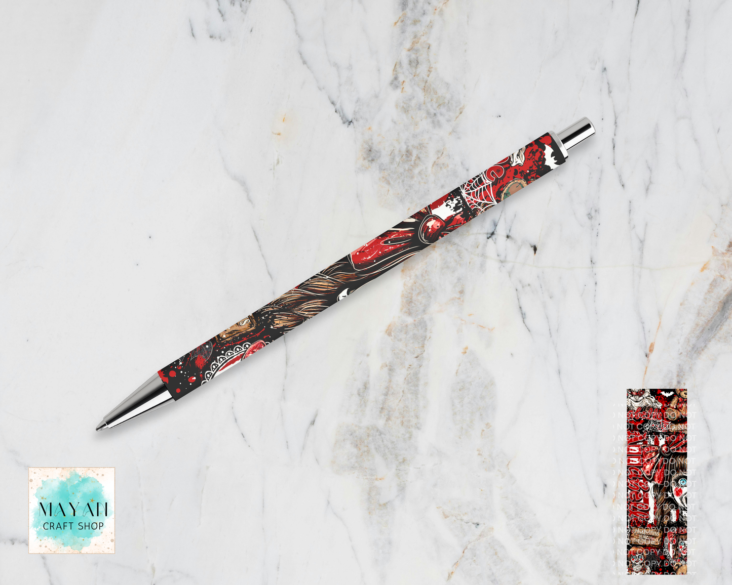 A decorative ballpoint pen with a detailed red, black, and gold dragon illustration, displayed diagonally on a white marble background. A close-up detail of the dragon pattern is shown in a vertical strip on the bottom-right.