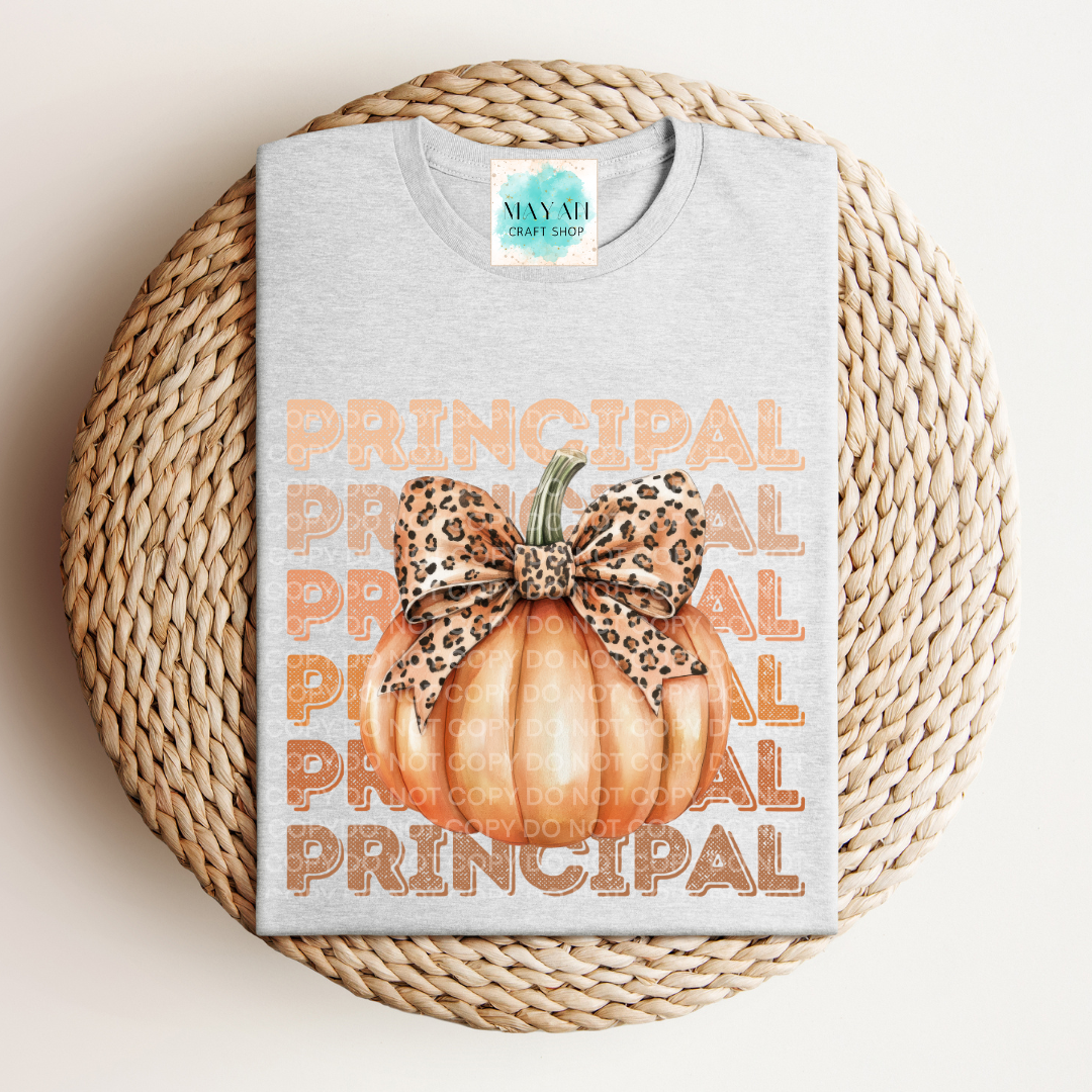 Gray t-shirt with 'Principal' text and pumpkin design on a woven surface