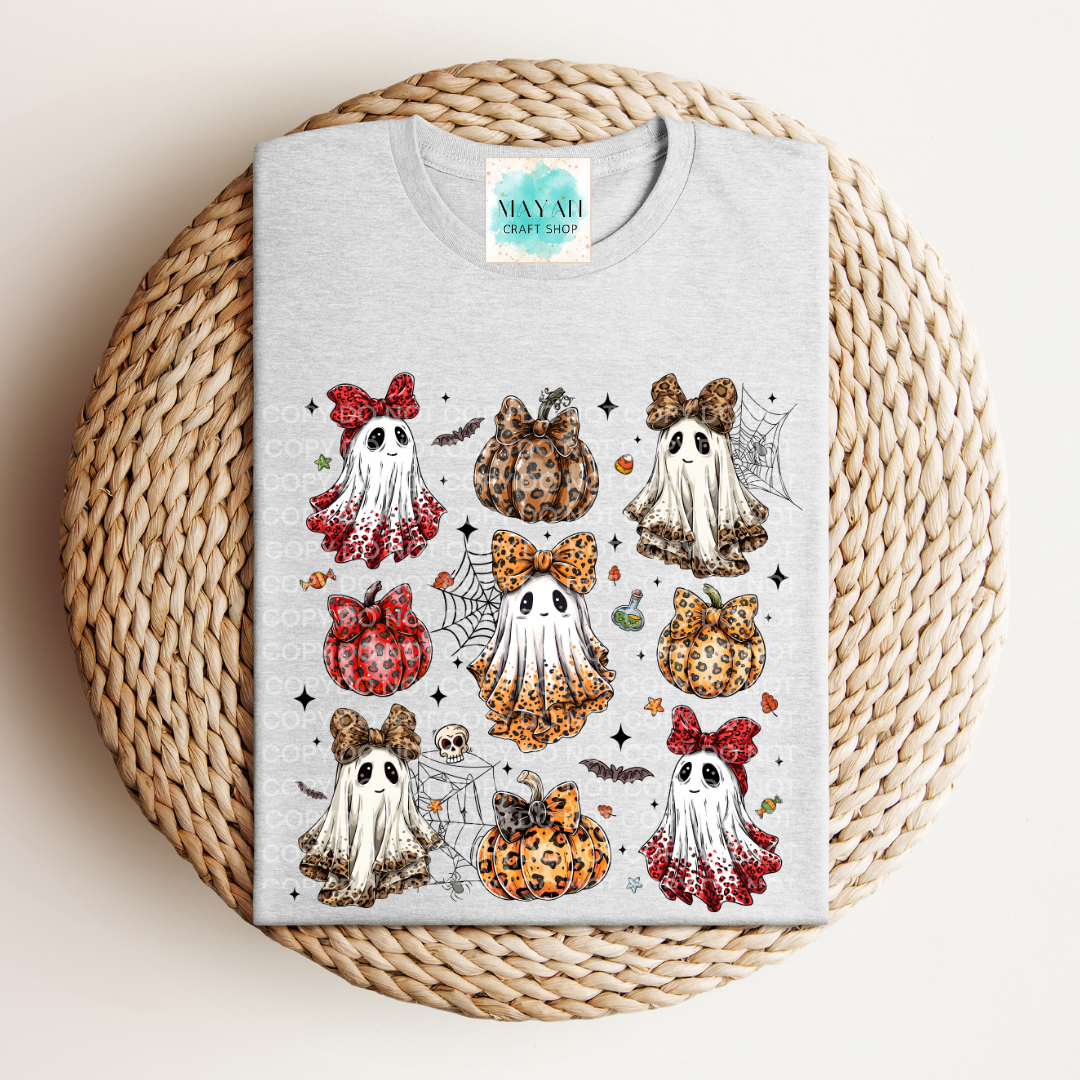 Gray t-shirt with Halloween-themed designs on a woven surface