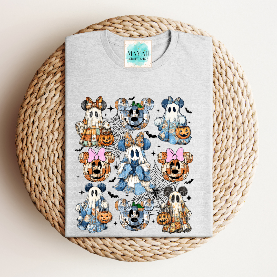 Gray sweatshirt with Halloween-themed cartoon characters on a woven mat