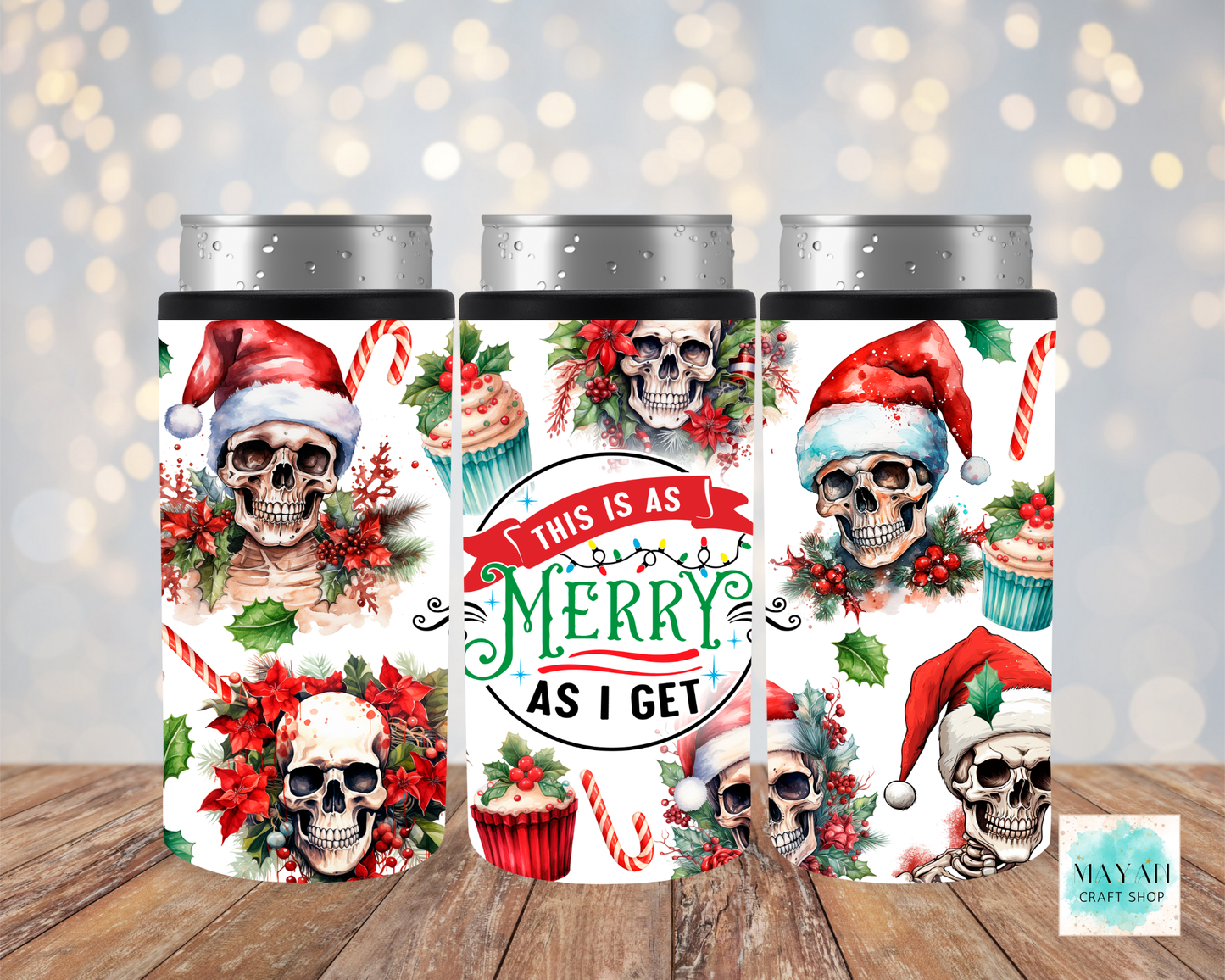 Three cylindrical containers with skull designs and Christmas-themed text on a wooden surface.