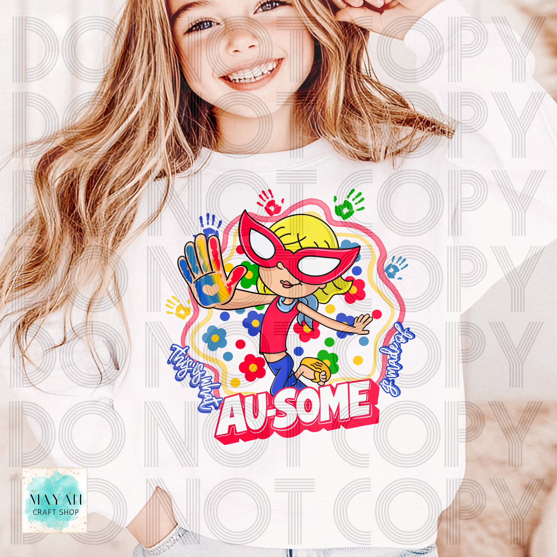 Child wearing a colorful t-shirt with a superhero design and 'AU-SOME' text.