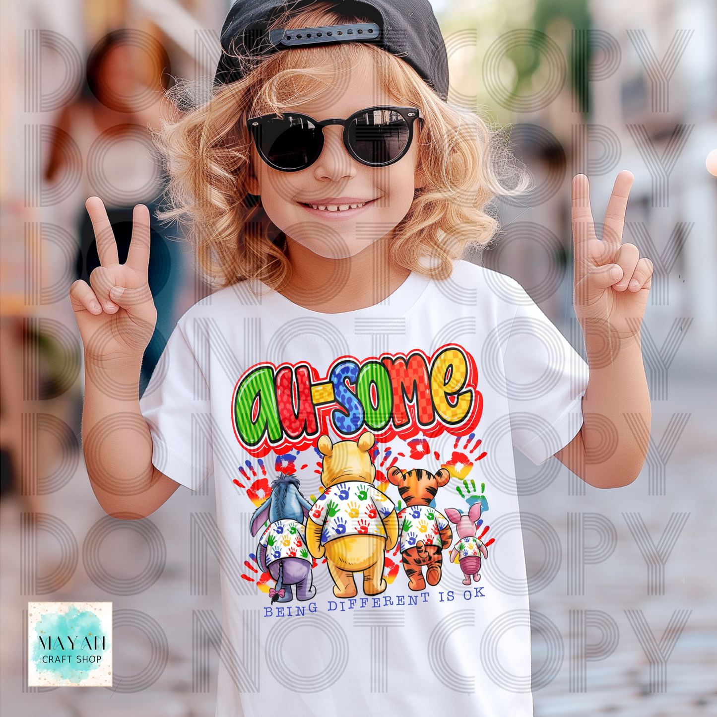 Child wearing a white t-shirt with colorful graphics and text, making peace signs.