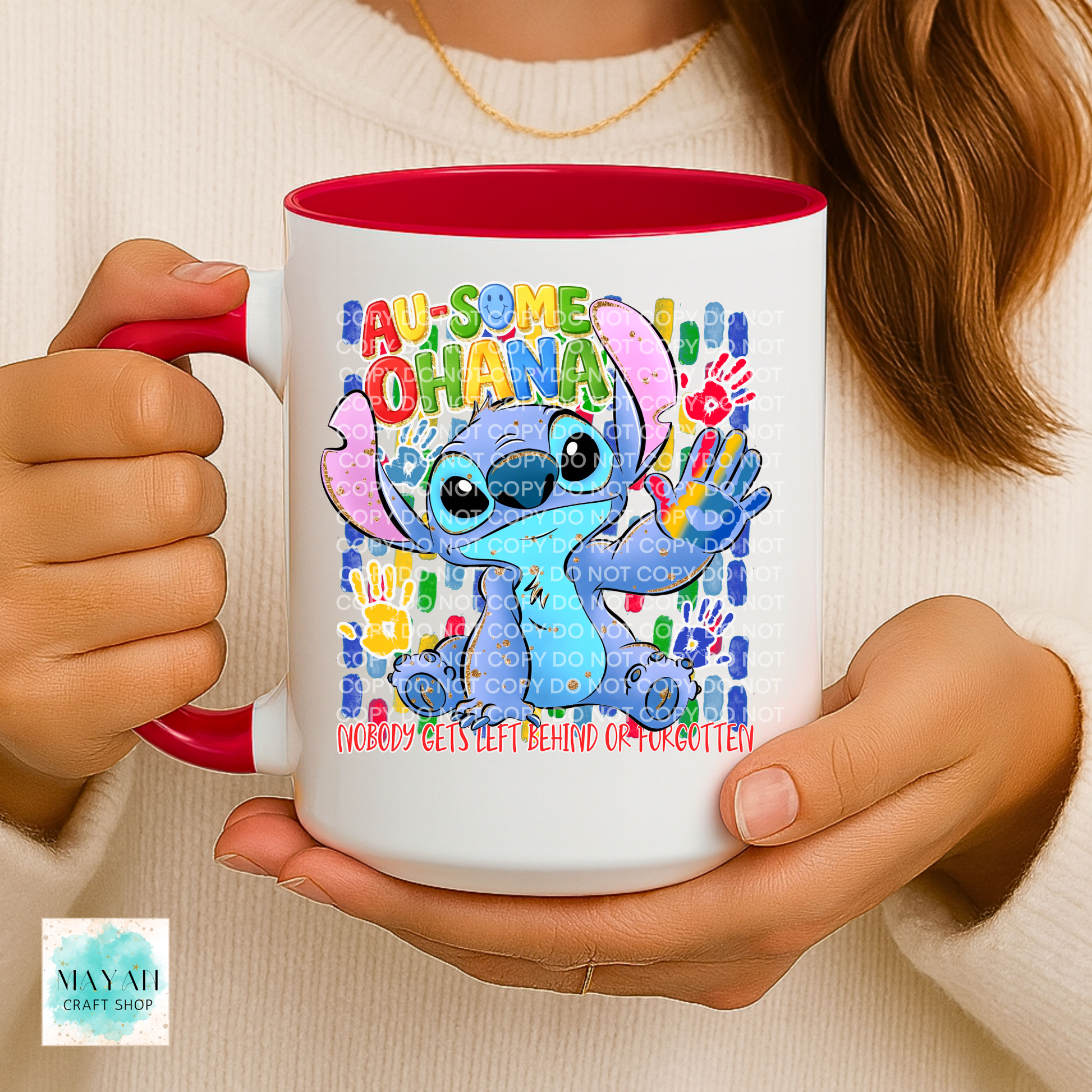 Person holding a mug with a colorful design featuring a character and text.