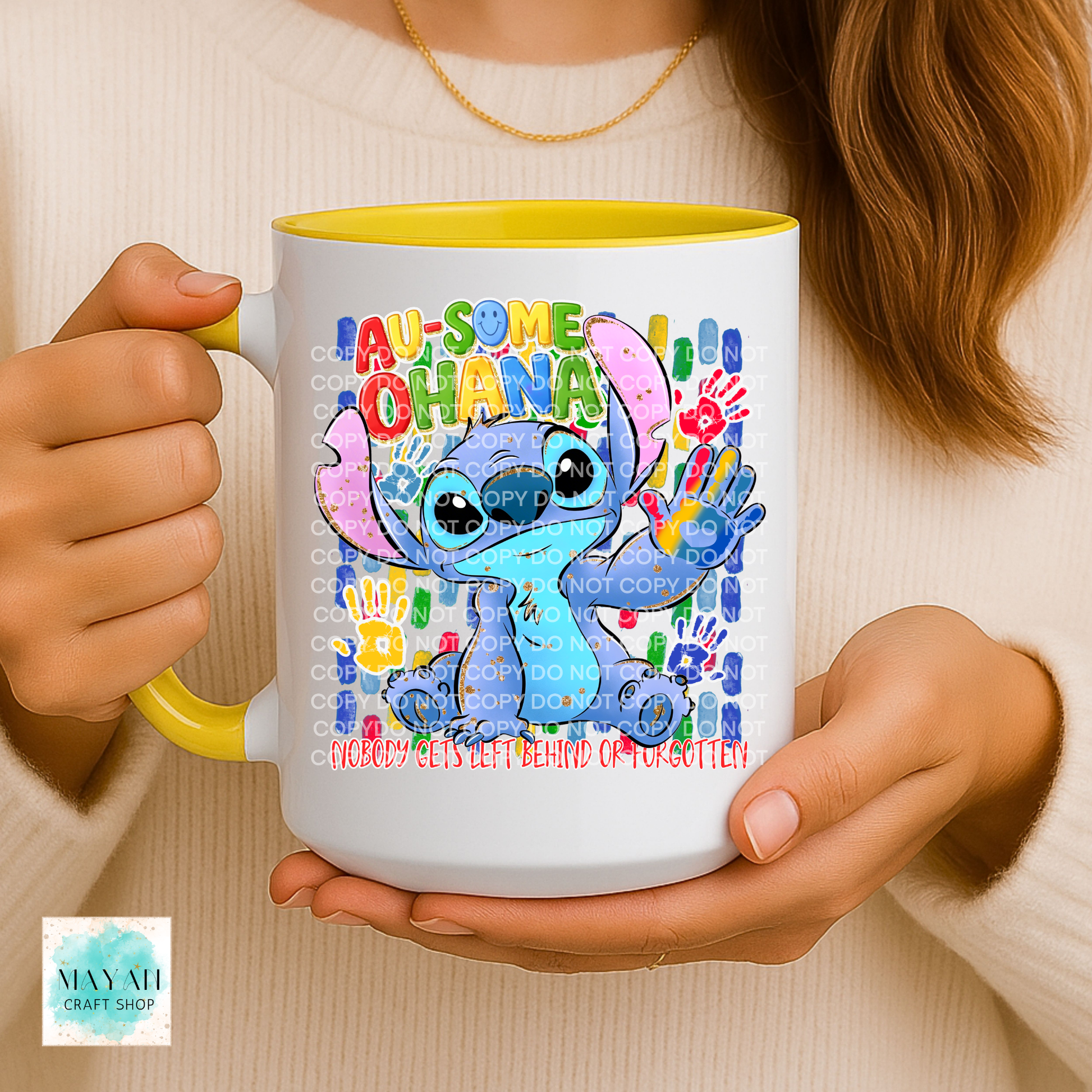 Person holding a mug with a colorful design featuring a character and text.