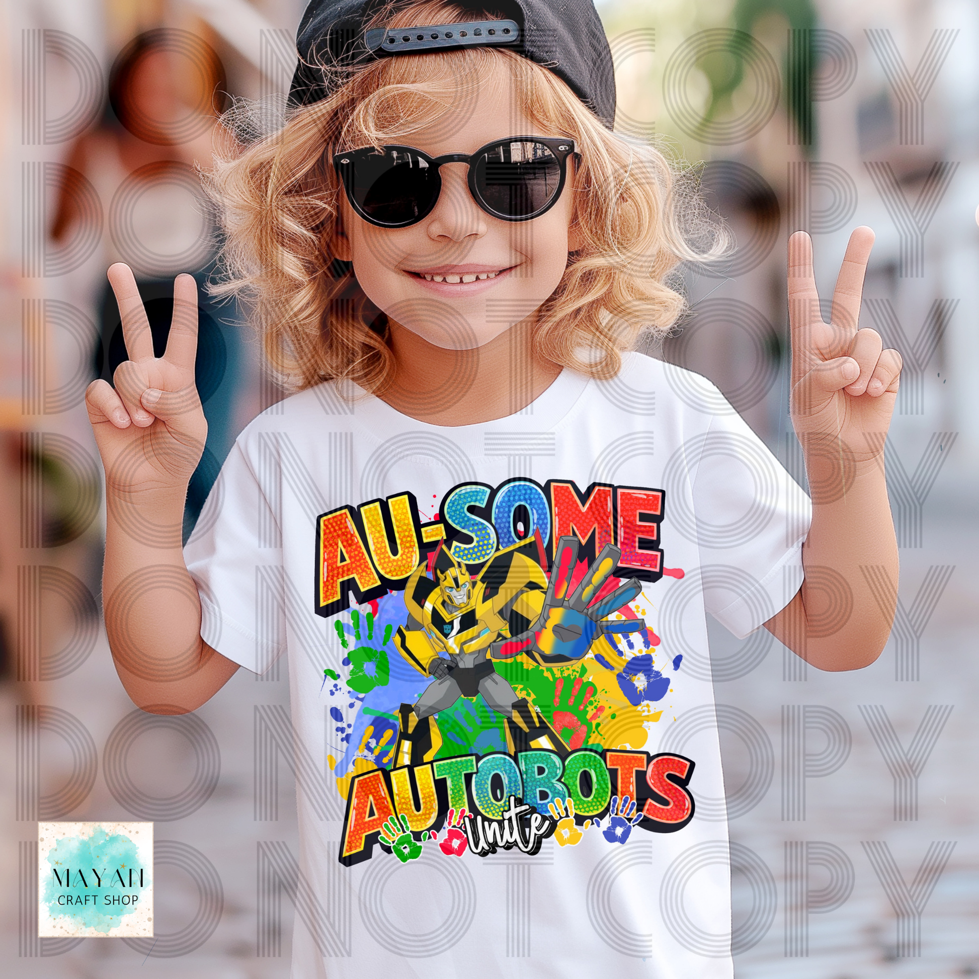 Child wearing a white t-shirt with colorful design, making peace signs.