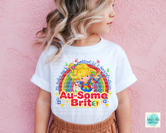 Child wearing a white t-shirt with colorful graphics and text against a pink background