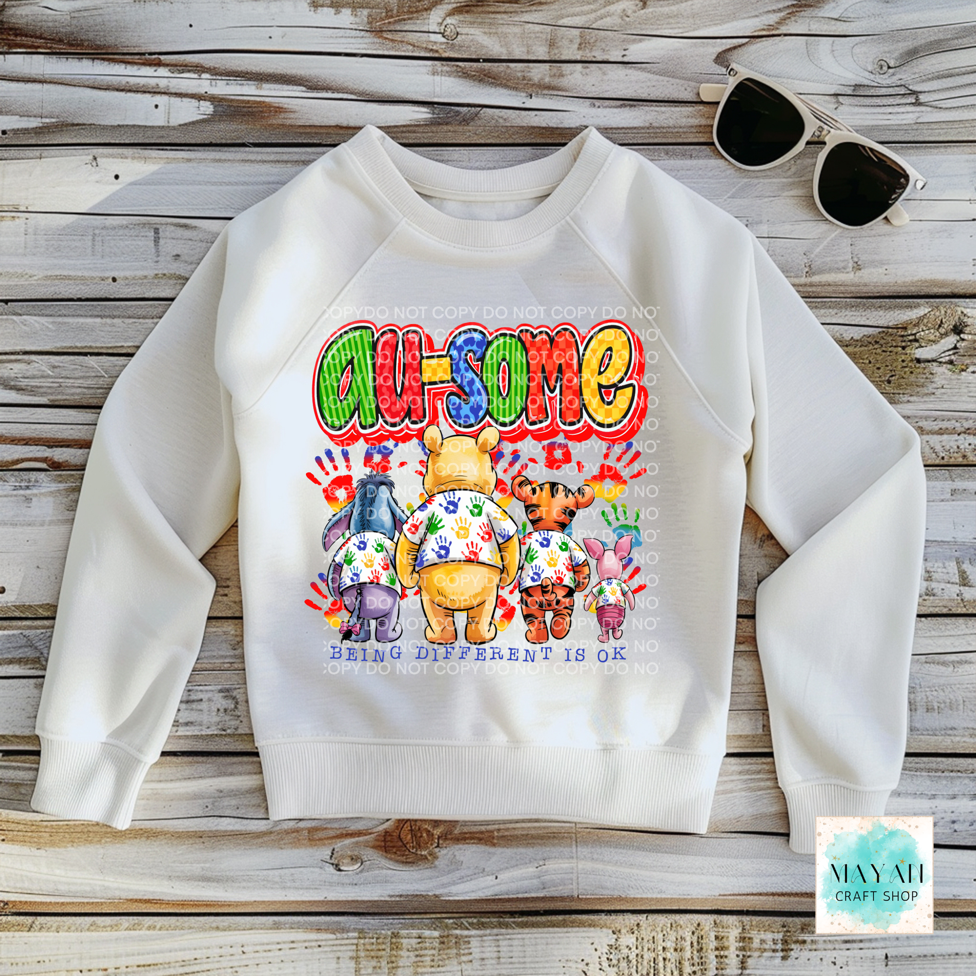 White sweatshirt with colorful graphic design on a wooden surface