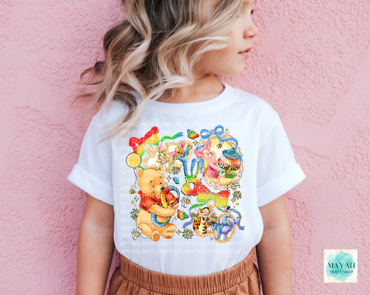 Child wearing a white t-shirt with colorful cartoon characters against a pink background