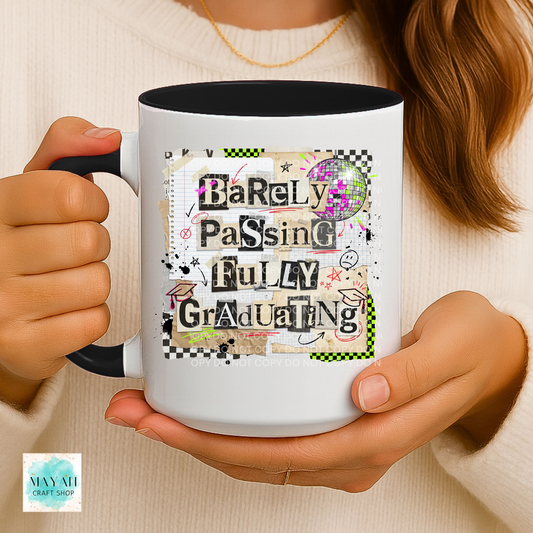 Person holding a mug with 'Barely Passing Fully Graduating' text design.