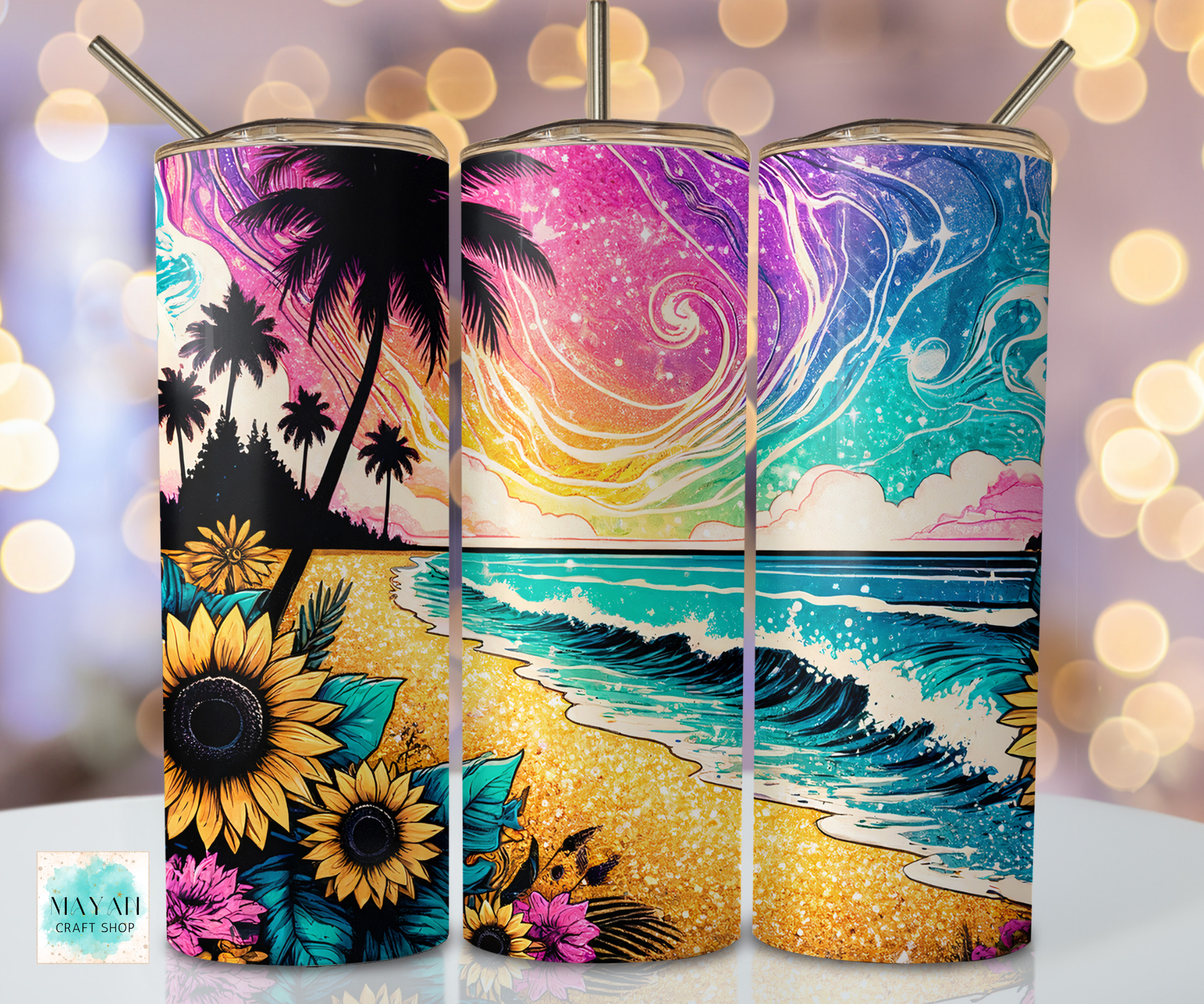 Three colorful tumblers with beach-themed designs on a blurred bokeh background.