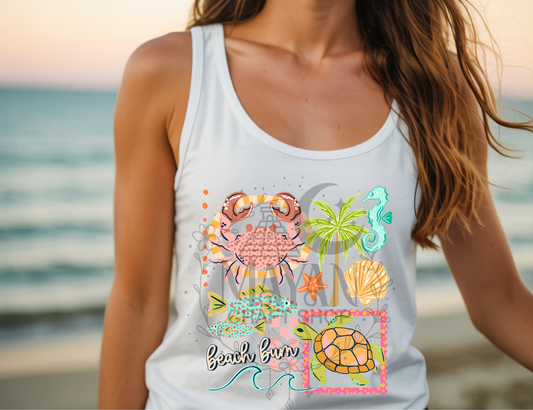 Person wearing a white tank top with beach-themed designs and 'Beach Bum' text, standing by the ocean.