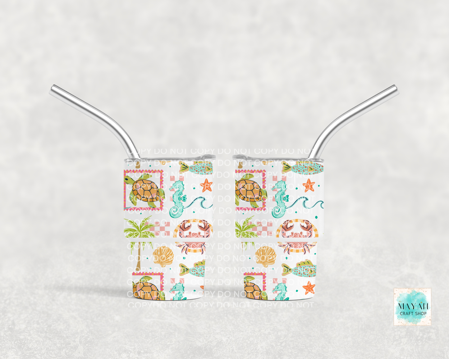 Two mini tumblers with metal straws on a white background, featuring sea-themed designs.