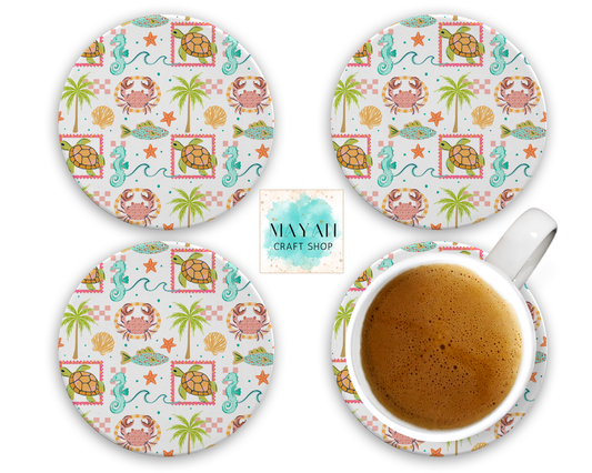 Set of four coastal-themed coasters with a cup of coffee on a matching coaster.
