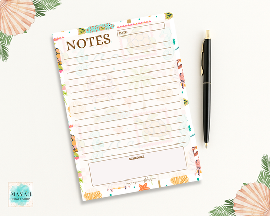 Floral notepad with a pen on a white background
