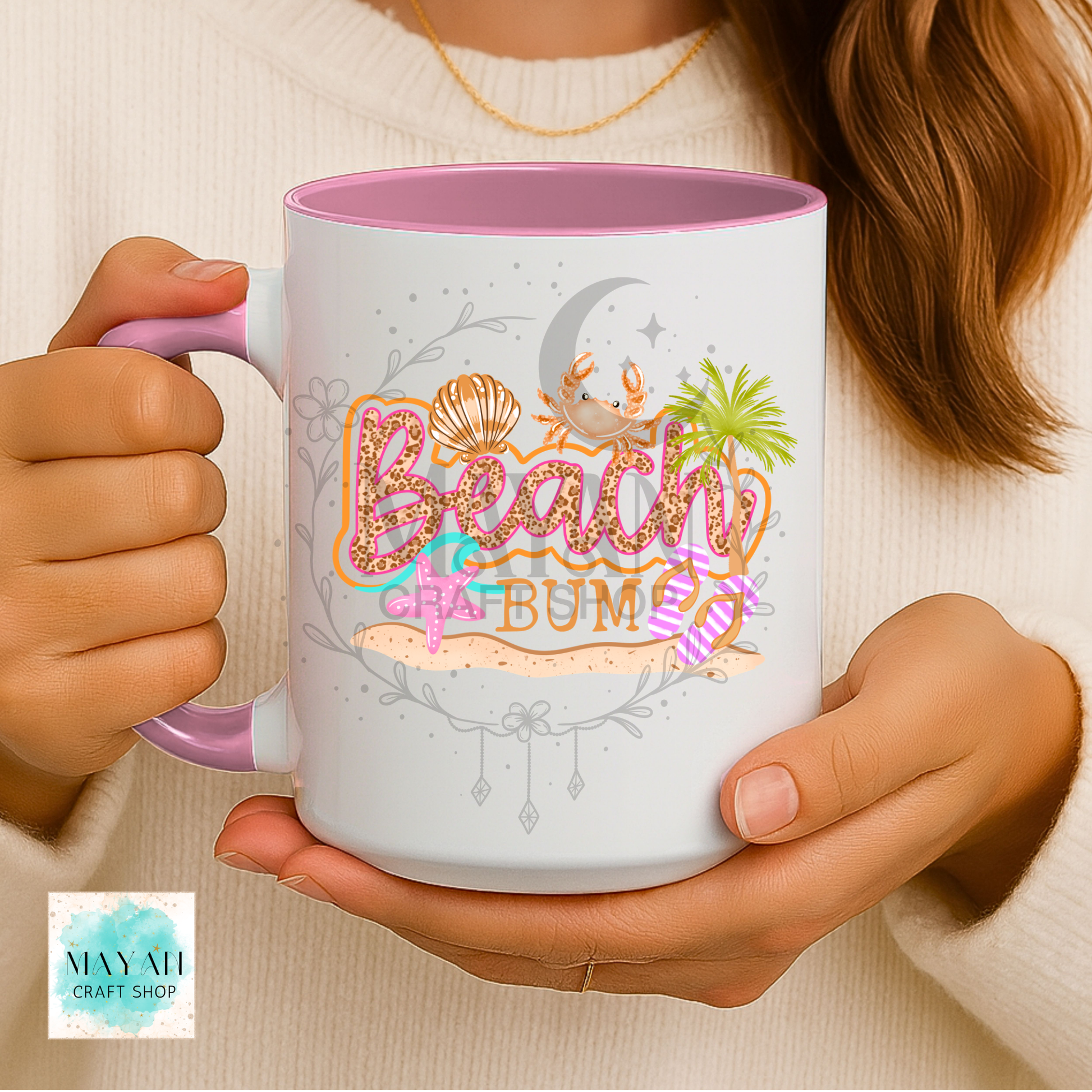 Person holding a mug with 'Beach Bum' design and May All Craft Shop logo.