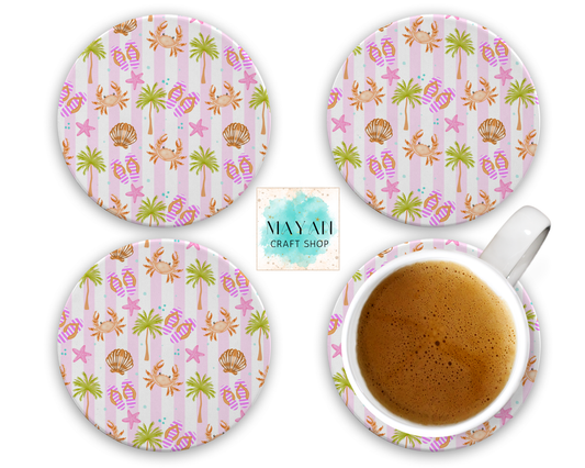 Set of four tropical-themed coasters with a cup of coffee on a white background.