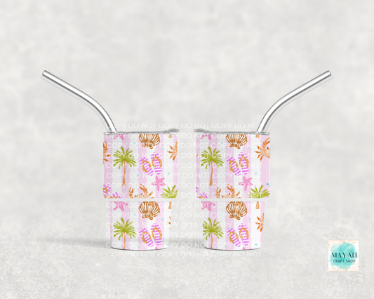 Two mini tumbler cups with tropical pattern and metal straws on a light gray background