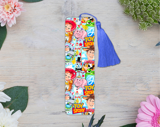 Colorful bookmark with characters on a wooden surface with flowers.