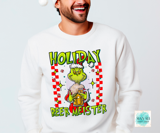 Person wearing a white sweatshirt with a festive design featuring a character and text.