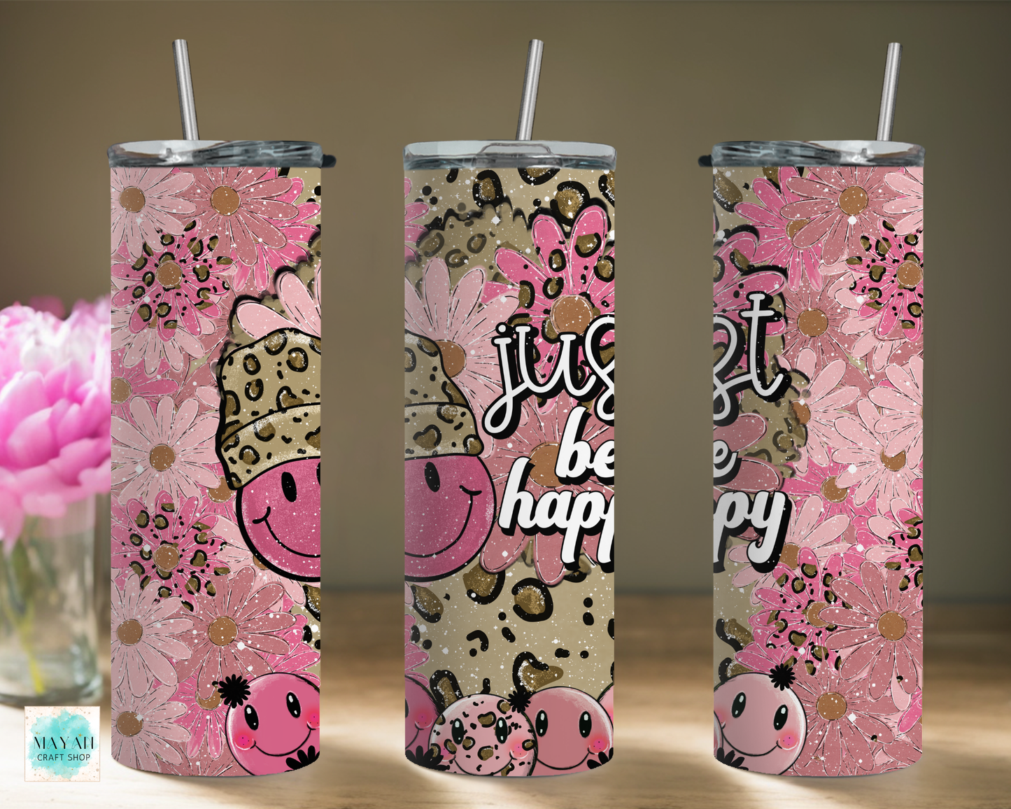 Three pink tumblers with floral and animal print designs on a neutral background.