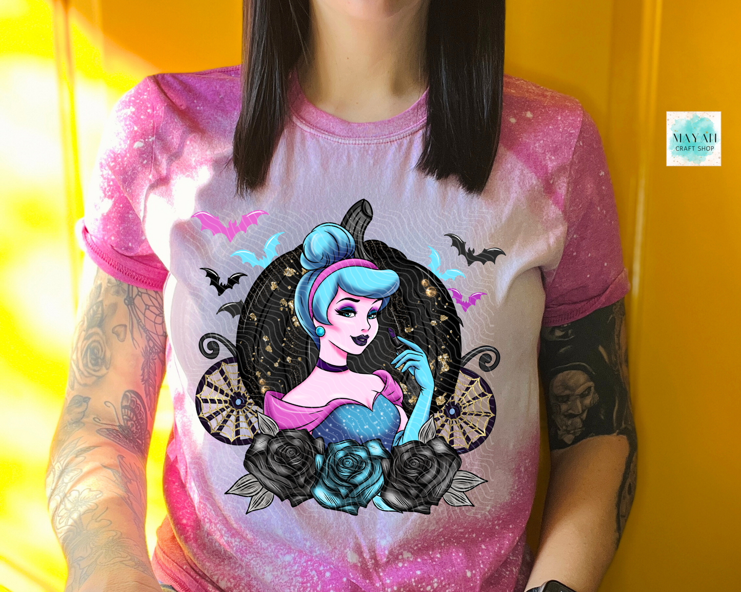 Person wearing a t-shirt with a colorful graphic design on a yellow background