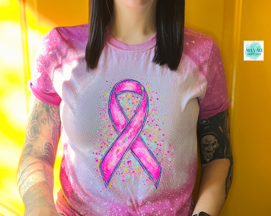 Person wearing a shirt with a pink ribbon design against a yellow background