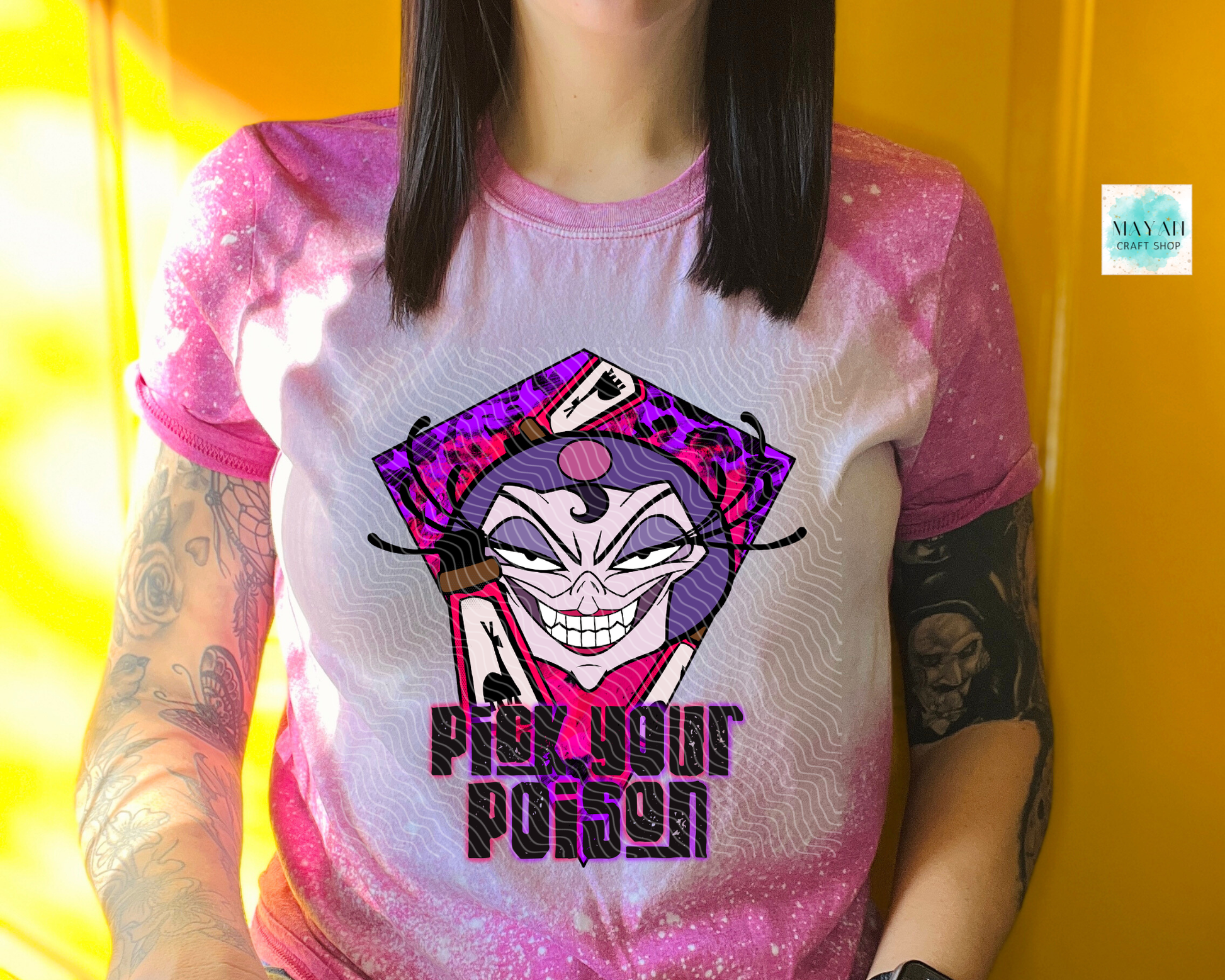 Person wearing a t-shirt with a colorful graphic design and text against a yellow background