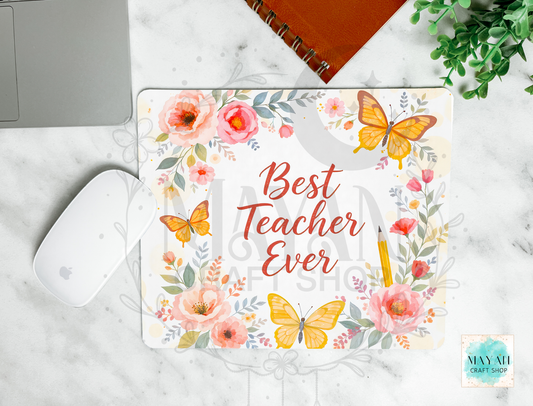 Mouse pad with 'Best Teacher Ever' design on a marble surface with laptop and mouse.