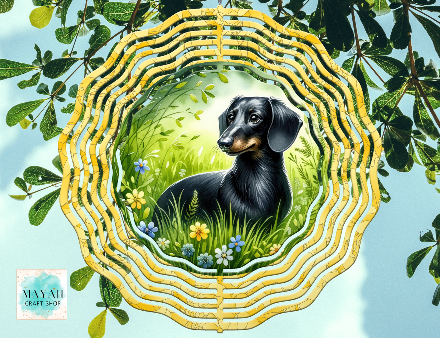 Decorative wind spinner with a dachshund in a natural setting, surrounded by leaves and flowers.