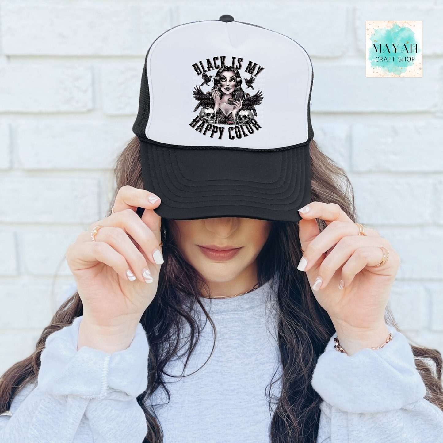 Person wearing a cap with 'Black is my happy color' text and graphic.