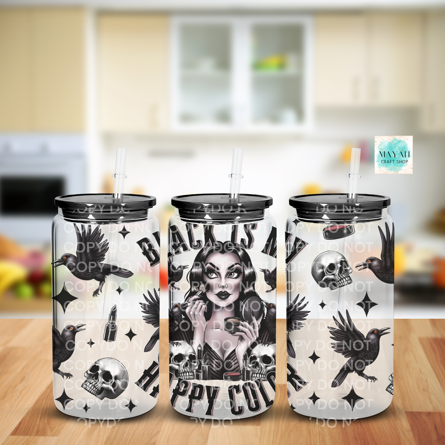 Three frosted glass cans with black and white designs on a kitchen counter.