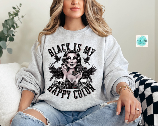 Person wearing a gray sweatshirt with a graphic design and text, sitting on a couch.