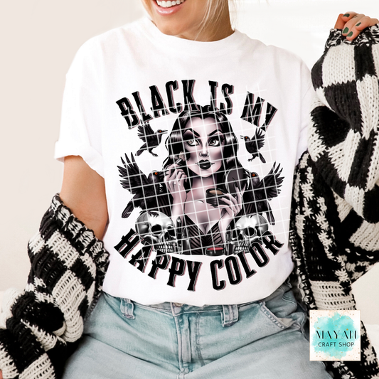 Person wearing a white t-shirt with a graphic design and text, holding a black and white patterned item.