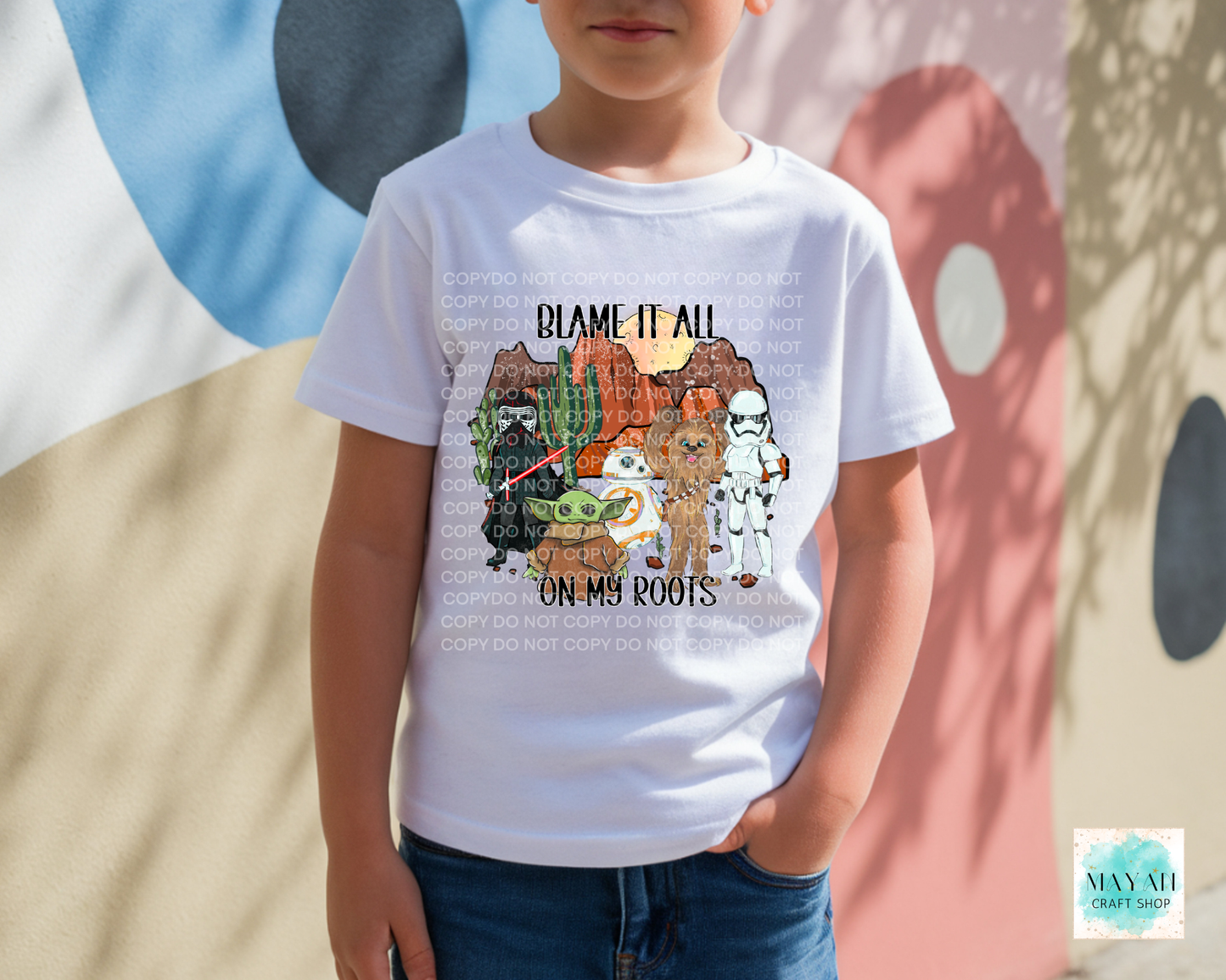 Child wearing a white t-shirt with a graphic design and text, standing against a colorful abstract background.