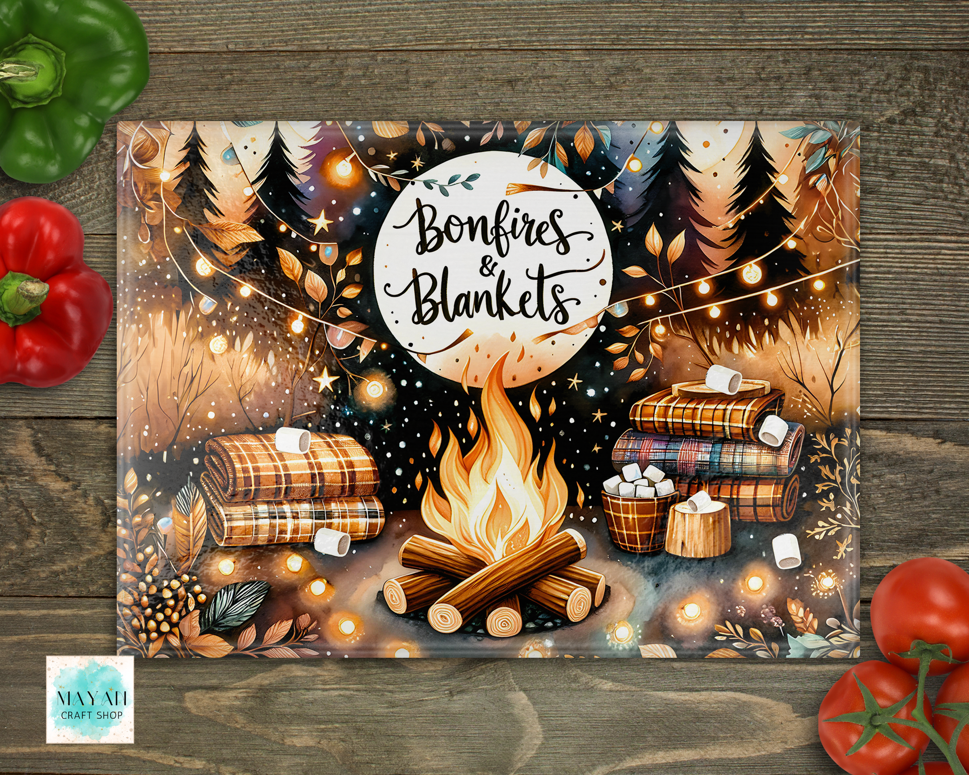 Decorative mat with 'Bonfires & Blankets' design featuring a campfire and blankets on a wooden surface.