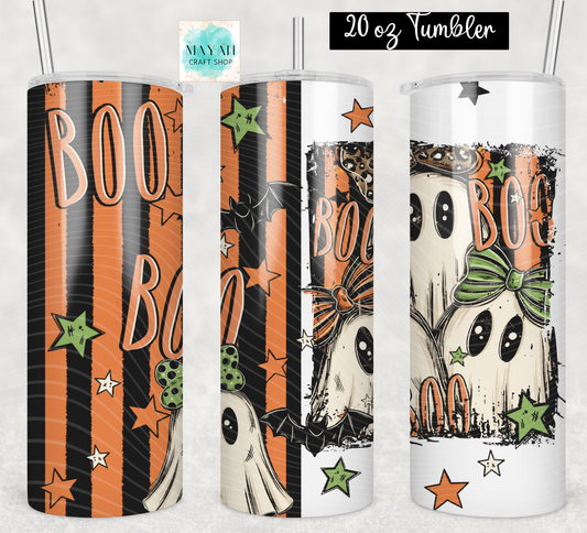 Three views of a 20 oz skinny tumbler with a Halloween theme, featuring orange and black stripes, ghosts, bats, stars, and the word 'BOO'. The left tumbler has a black base with orange stripes and peach 'BOO' text.