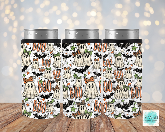 Three slim can coolers with a Halloween-themed pattern featuring cartoon ghosts, bats, stars, shown on a wooden surface with a soft bokeh light background.