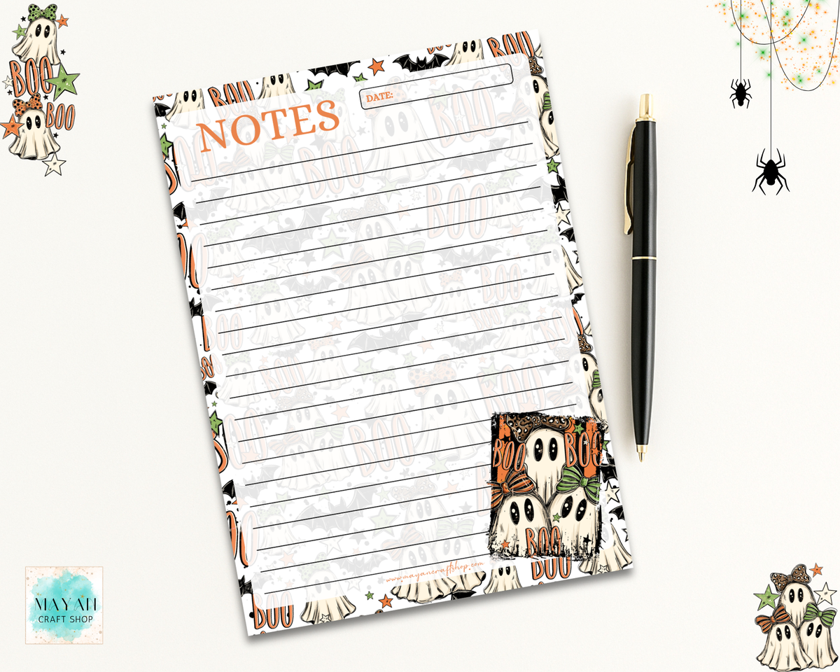 A Halloween-themed lined notes pad with a 'BOO' header and owl illustrations, shown on a light background with a black pen and decorative ghost and spider graphics.